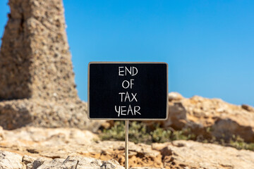 End of tax year symbol. Concept words phrase End of tax year on beautiful black blackboard....