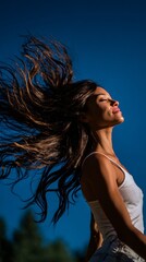 Carefree Woman Enjoying Outdoor Breeze on a Sunny Day with Flowing Hair