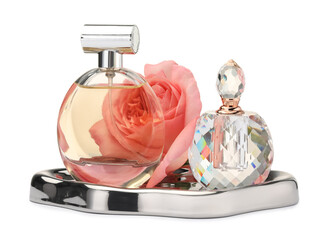 Different perfume bottles and rose isolated on white