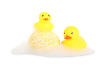 Cute rubber ducks and sponge with foam isolated on white