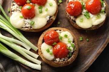 Tasty stuffed mushrooms served on table, top view