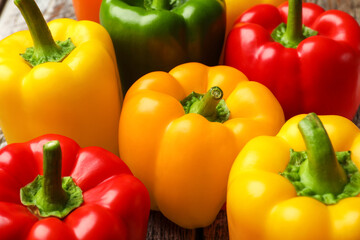 Fresh colorful bell peppers on table, closeup