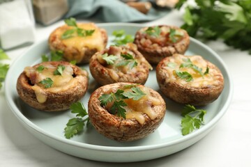 Tasty stuffed mushrooms and spices on white marble table, closeup