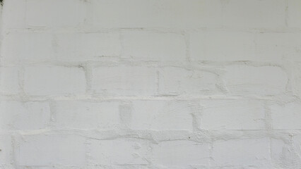 White painted brick wall, rough texture, uneven, thinly painted until the brick wall is visible, texture and background images.
