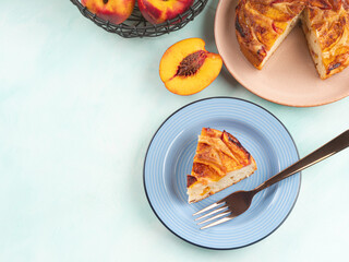 Piece of nectarine peach cake on turquoise table