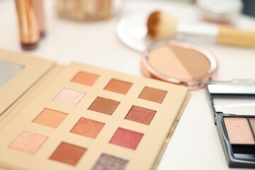 Different makeup products on white table, closeup