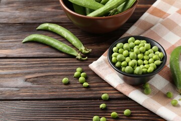Fresh ripe green peas on wooden table, closeup