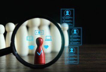 Employee search. Red pawn among white ones on table, view through magnifying glass