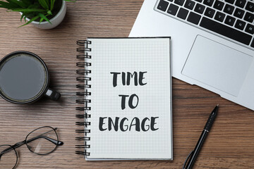 Time To Engage phrase written in notebook on office desk, top view