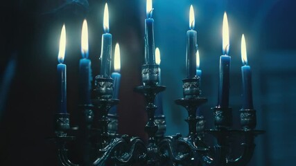 A lit chandelier in a dark room, perfect for a dramatic scene or setting the mood