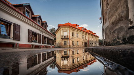 Naklejka premium Vilnius City Uzupis Republic Sightseeing Areea in Lithuania. Old Buildings and Reflection on Water.