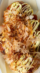 Close-up of Takoyaki with mayonnaise squirted on top 