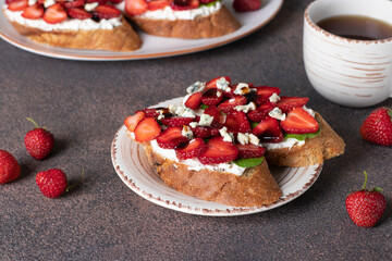Bruschetta with strawberries, arugula and dor bleu cheese for breakfast