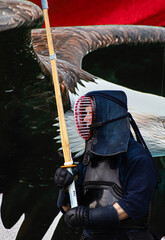 Man in Kendo Armor with a wooden sword 