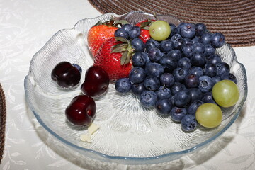 fresh berries and strawberry on a plate