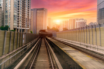 Naklejka premium Train view. blurry speed motion on railway tunnel for futuristic connection technology. Abstract background at sunset time.