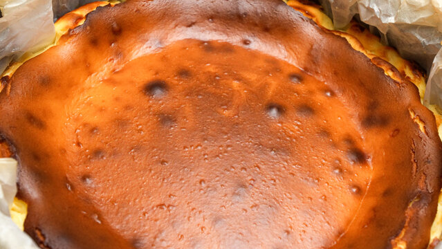 Delicious Cheesecake With caramel Crust And Creamy Filling Baked To Perfection standing on baking rack