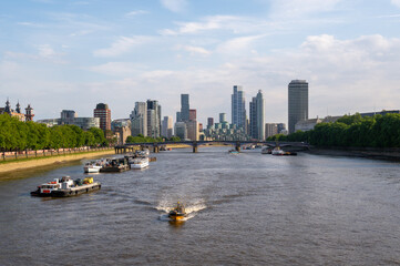 Cityscape of London with Boats on the river Themse.