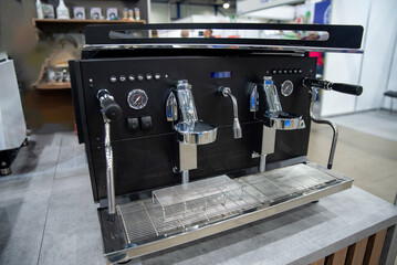 Dual-group espresso machine with chrome heads, gauges and steam wands