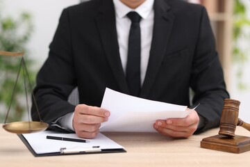 Judge working at wooden desk indoors, closeup