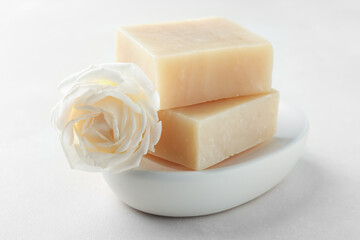 Aromatic soap bars and rose on light table