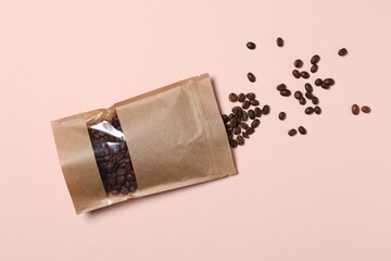 One zipper stand-up pouch with coffee beans on pink background, flat lay. Mockup for design