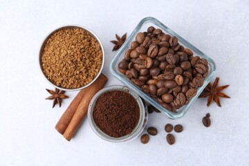Different types of instant coffee, beans and spices on light table, flat lay