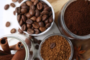 Different types of instant coffee, beans and spices on light table, flat lay
