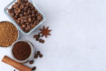Different types of instant coffee, beans and spices on light table, flat lay. Space for text