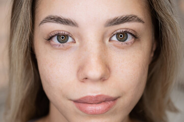 Close-up portrait of a woman after eyelash lamination procedure. 