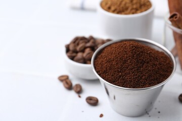 Instant coffee powder and beans on light table, selective focus. Space for text