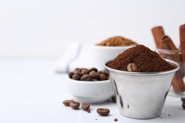 Instant coffee powder and beans on light table, selective focus. Space for text