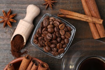 Roasted beans, instant coffee powder and spices on wooden table, flat lay