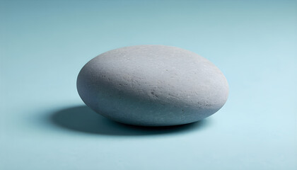 Smooth Grey River Stone on Light Blue Surface