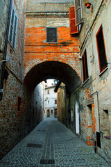 COMUNANZA, ITALY - AUGUST 14, 2022: Via Sarti in Comunanza. Via Sarti in Comunanza is a cozy street where tradition meets daily life, lined with local shops and a warm, inviting atmosphere