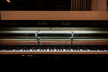 Inside grand piano showing hammers and keys ready for playing music