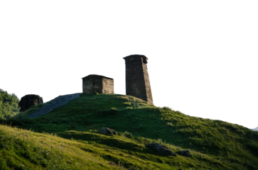 Ancient stone towers on a green hill against the sky historical architecture of the Caucasus transparent background