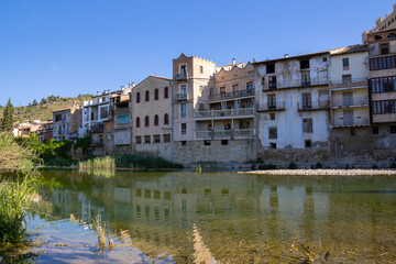 Panoramic view of Valderrobres, showing the ancient stone bridge, medieval architecture, and Santa María la Mayor Church.
