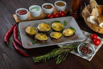 Mushroom shashlik with cheese on wooden background
