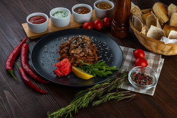 Viennese salad with beef tongue and sauces on wooden background