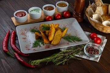 Potato wedges in village style on wooden background