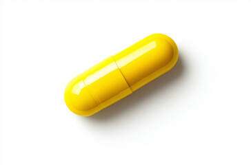 Top-down photo of a yellow capsule on a white background