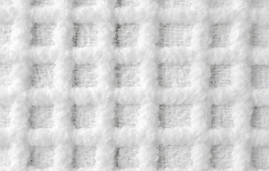 White fabric background with a fine, textured weave pattern. Ideal for use in wallpaper, carpet, or interior design visuals where a subtle, clean, and detailed textile look is needed