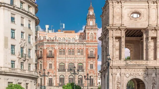Morning timelapse of Central de Telefonica and the Town Hall in Plaza de San Francisco, Seville. Casa Consistorial, a masterpiece of Plateresque architecture with tram under a blue cloudy sky