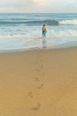 Yung  man by the sea enjoying freedom and life, people travel wellbeing concept. 