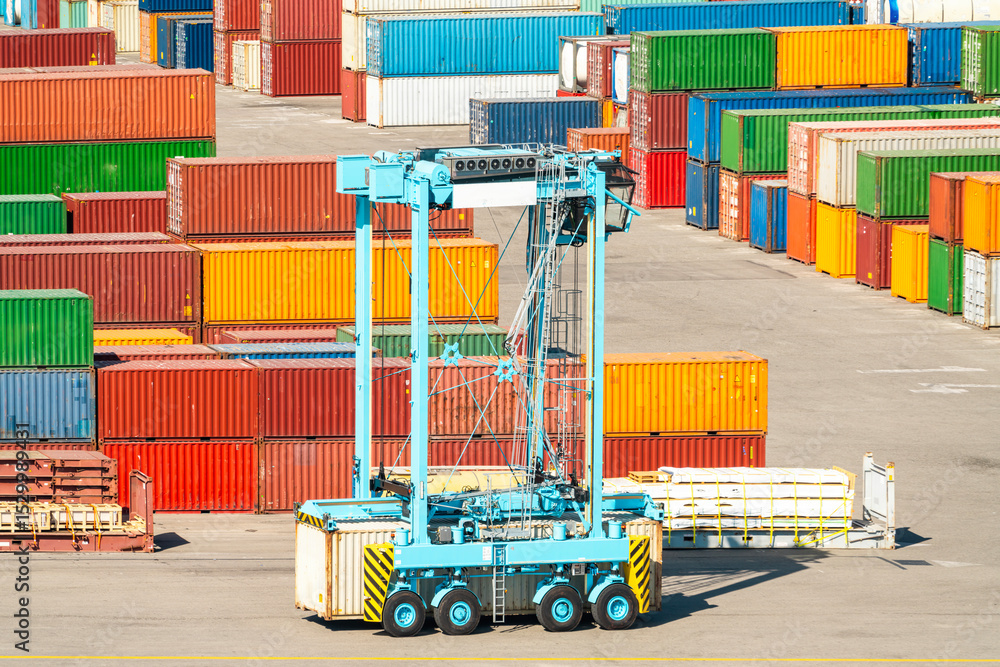 Poster container handler vehicle in cargo terminal with stacked multicolored cargo containers
