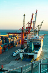 Empty Ro-Ro ferry at port terminal with cranes and containers