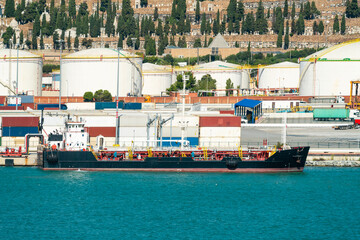 Oil tanker at Port of Barcelona with Montjuic cemetery backdrop