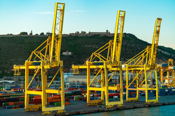Port cranes at container terminal, industrial harbor