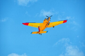 Yellow agricultural plane flies in the sky. small aviation, light aircraft